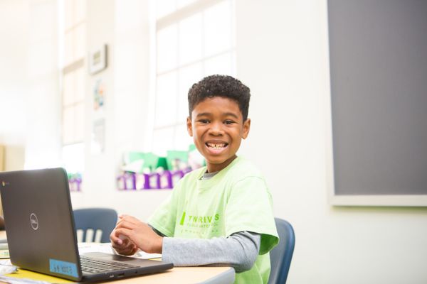 A student smiles, ready to learn.